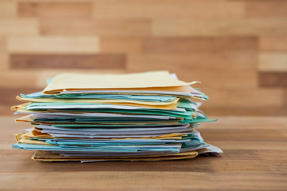 stack of folders containing old tax documents